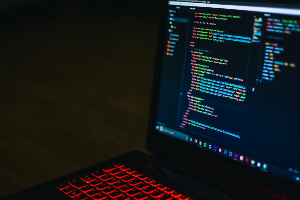 pexels photo 943096 943096 Red backlit keyboard and code on laptop screen create a tech-focused ambiance.